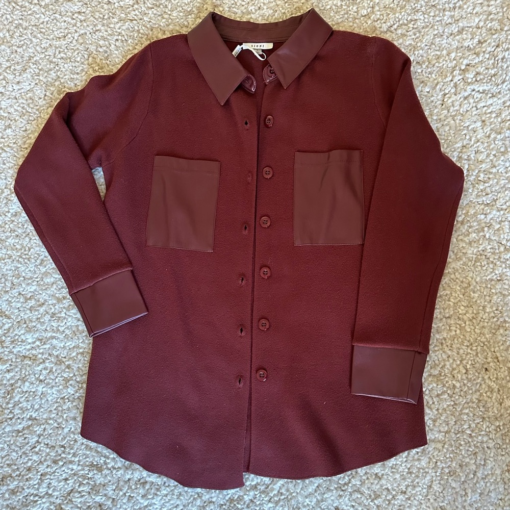 Burgundy shirt/sweater with a faux leather trimming and pocket details.